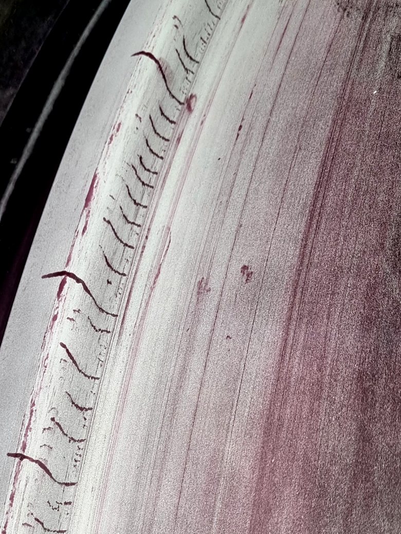 Linear dye penetrant indications along a machined surface, found by TechRay NDT